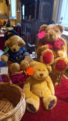 Three teddy bears on an antiques stall