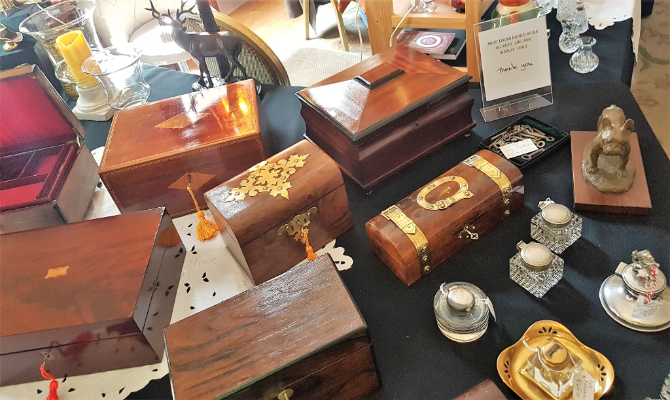 A range of wooden boxes on an antiques stall