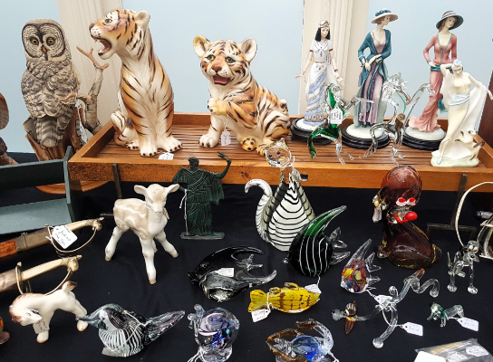 Ceramic and glass animals and statuettes on an antiques stall