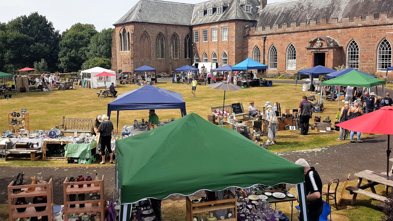 The Hartlebury Castle Carriage Circle bustling with people, antiques stalls and gazebos