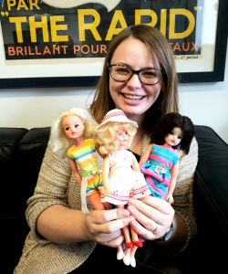 Specialist Kayleigh Davies holding up three dolls