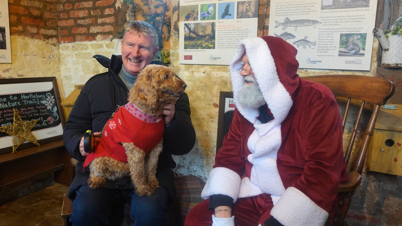 Dog and male owner meeting Santa in the Castle's nature bothy