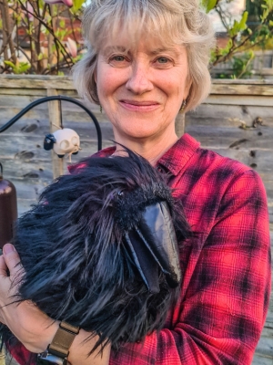 Woman holding a raven puppet