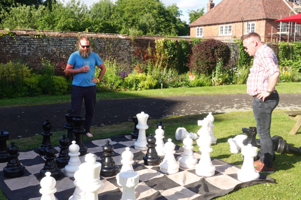 Two men playing outdoor chess at Hartlebury Castle