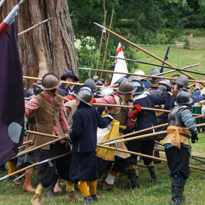 Dozens of soldiers with pikes fight close together in a Civil War battle re-enactment