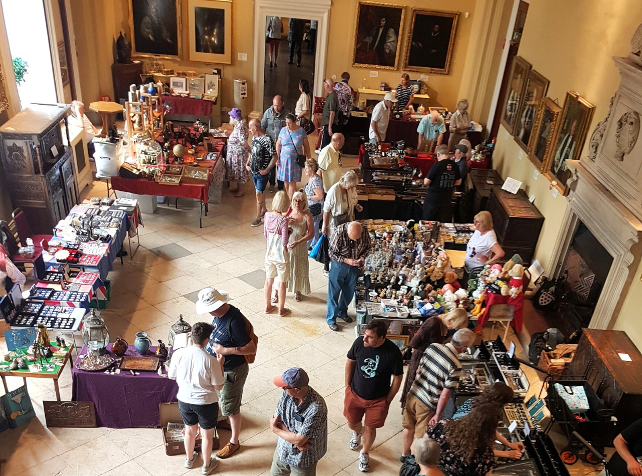 Visitors browsing at an Antiques Fair in the Hartlebury Castle Great Hall