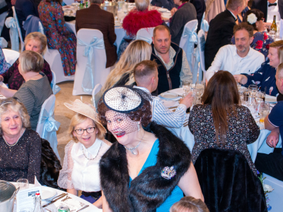 A dining audience with a murder mystery 1950s actor pulling a humorous face to the camera