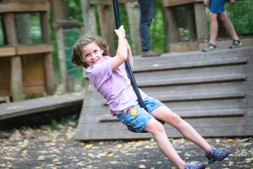 Girl riding a playground zipwire