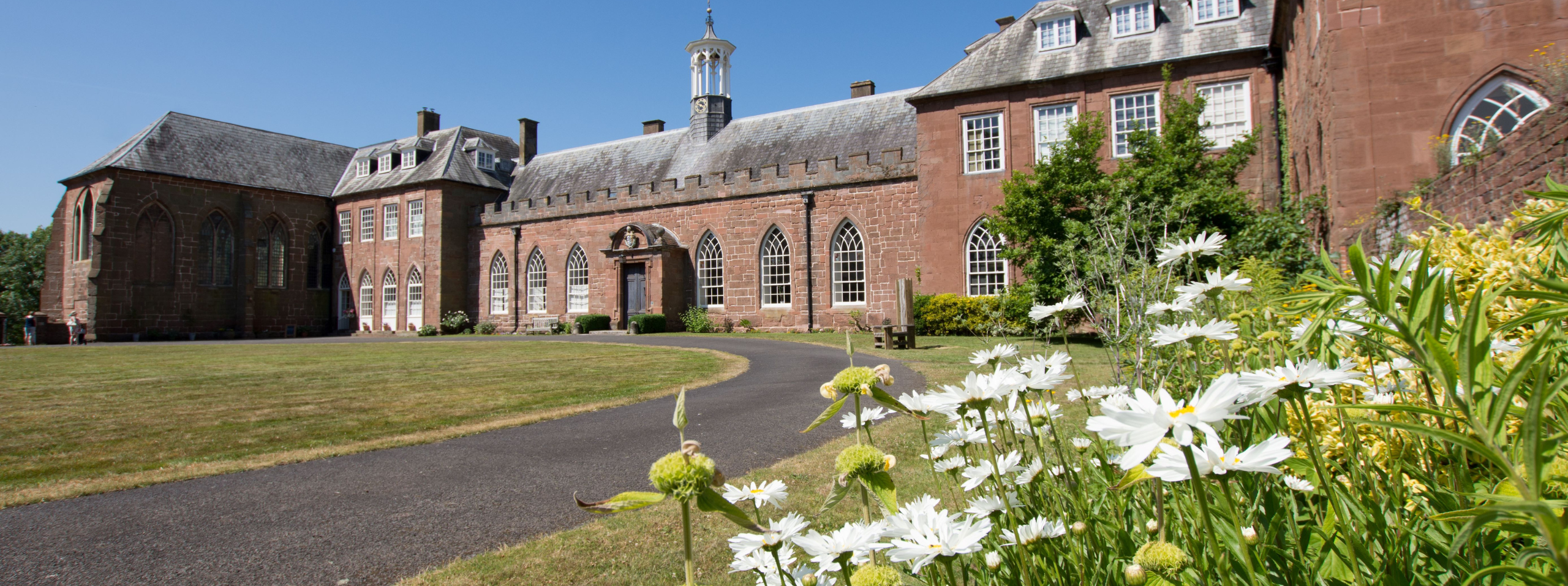 Exterior of Hartlebury Castle with flowers in the foreground